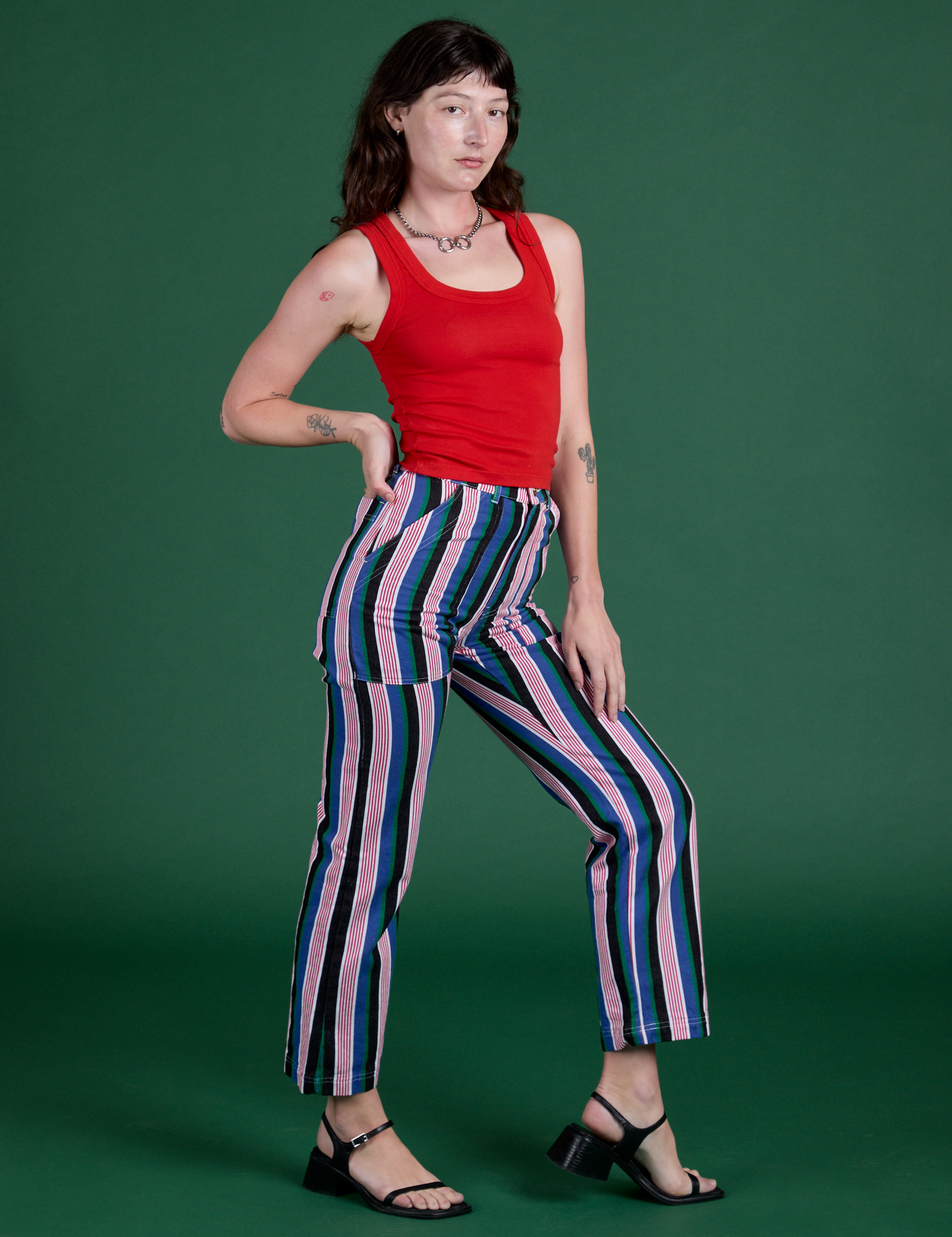 Angled front view of Work Pants in Pacific Stripe and mustang red Tank Top on Alex