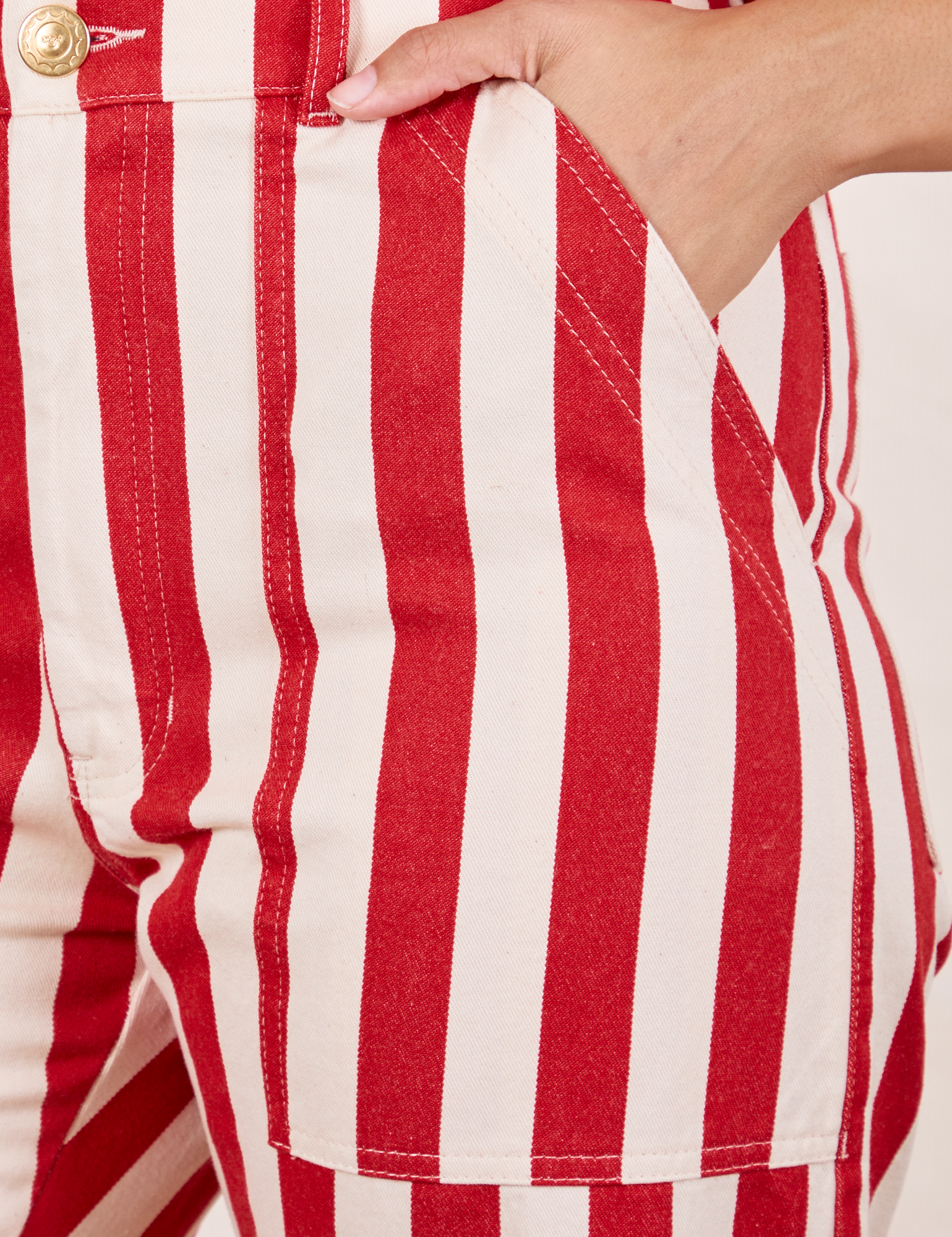 Work Pants in Cherry Stripe front pocket close up. Tiara has her hand in the pocket.