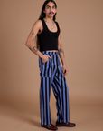 Angled front view of Black Stripe Work Pants in Cornflower Blue and black Cropped Tank on Anthony
