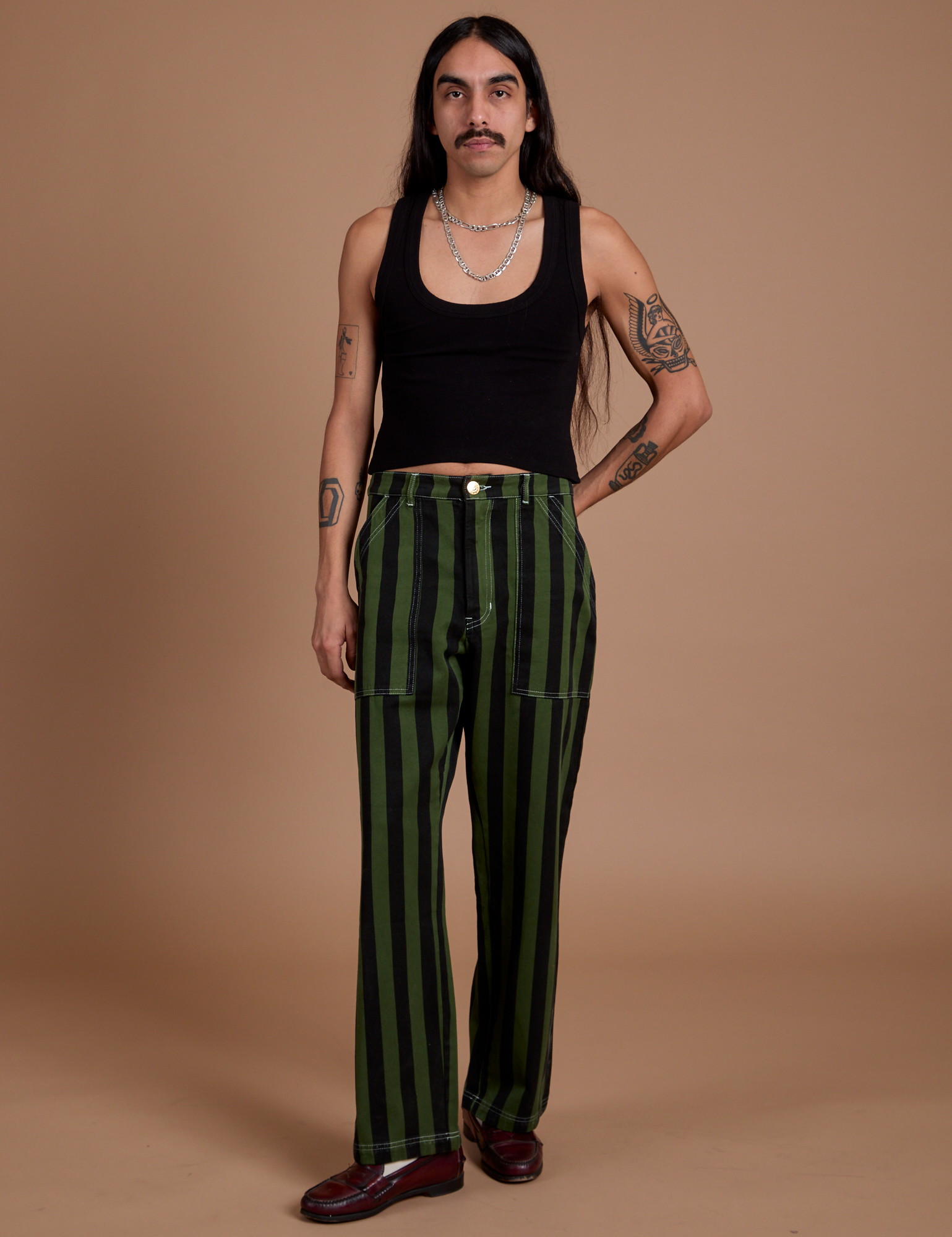 Anthony is 5’6” and wearing S Black Stripe Work Pants in Evergreen