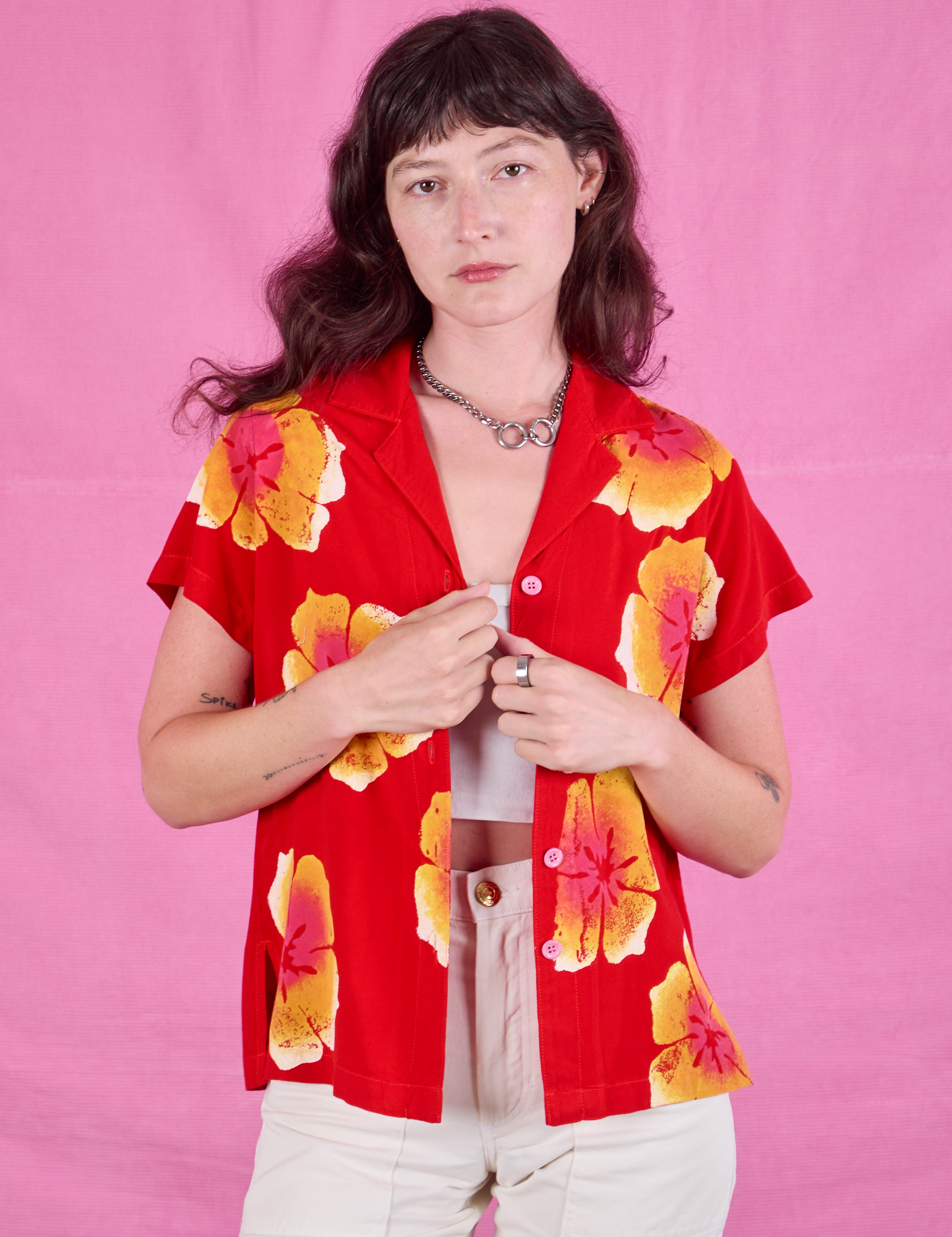 Alex is wearing a unbuttoned Paintstamped Pantry Button-Up in Mustang Red