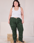 Ashley is 5'7" and wearing 1XL Carpenter Jeans in Swamp Green