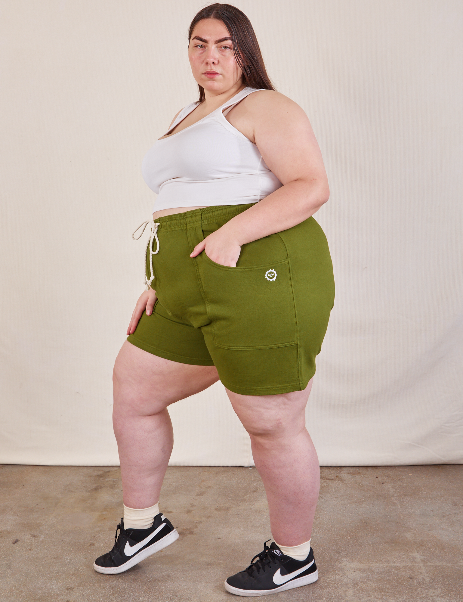 Side view of Lightweight Sweat Shorts in Summer Olive and Cropped Tank in vintage tee off-white on Marielena