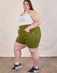 Side view of Lightweight Sweat Shorts in Summer Olive and Cropped Tank in vintage tee off-white on Marielena