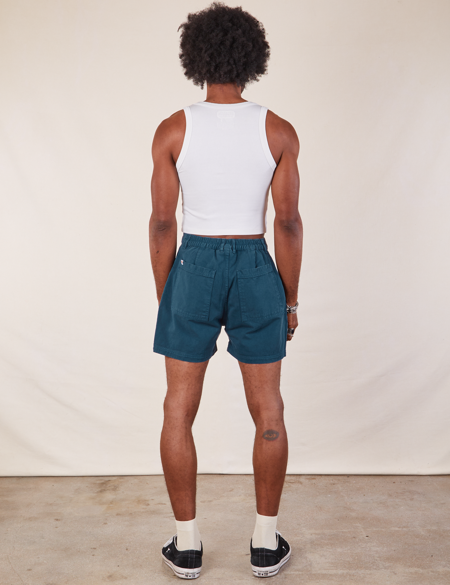 Back view of Western Shorts in Lagoon and Cropped Tank in vintage tee off-white on Jerrod