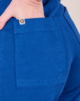 Close up of Alex's hand in the back pocket of Western Pants in Royal Blue