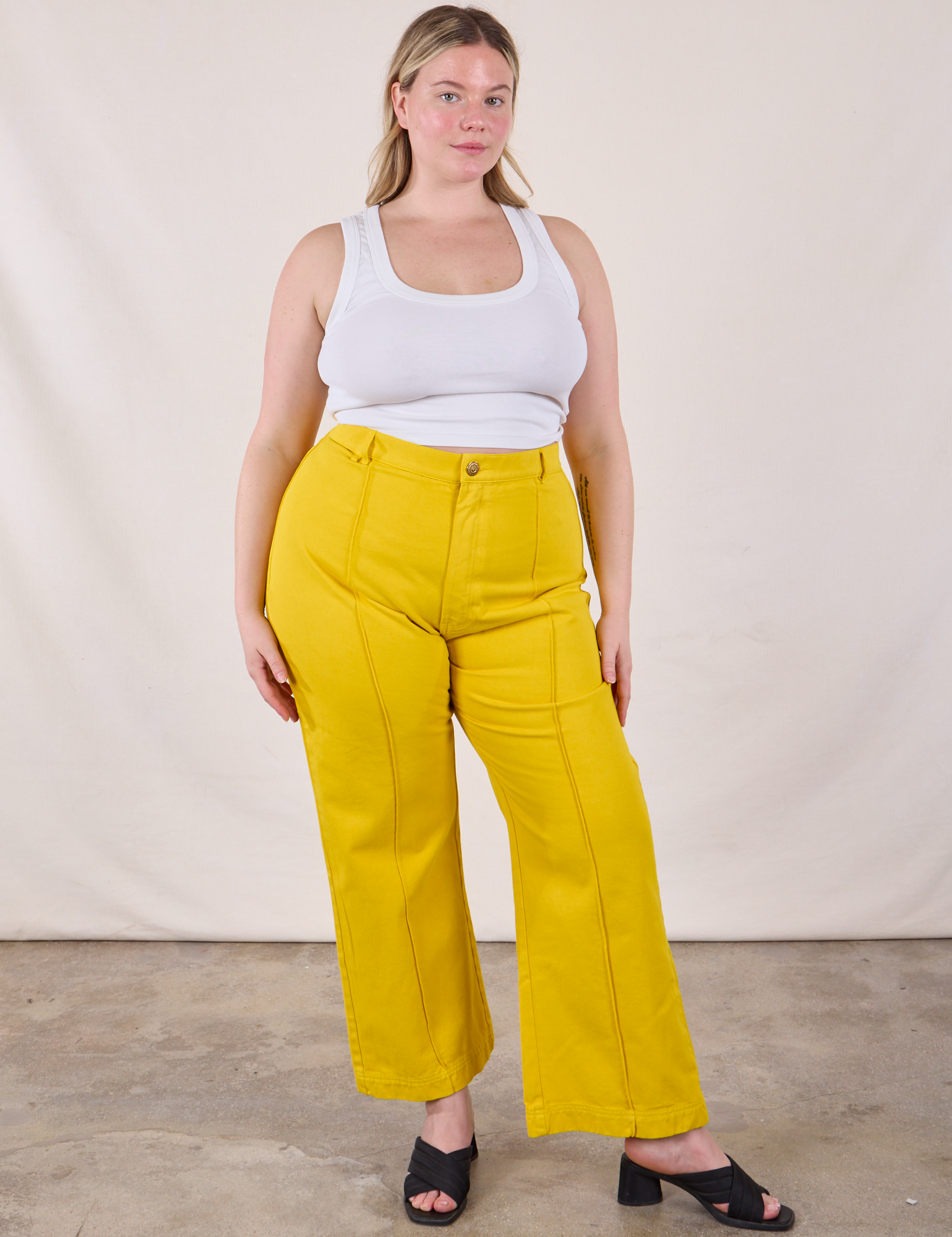 Lish is 5&#39;8&quot; and wearing XL Western Pants in Golden Yellow paired with a Cropped Tank in Vintage Tee Off-White