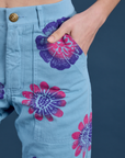 Close up of Madeline's hand in the front pocket of Floral Painted Work Pants in Blue