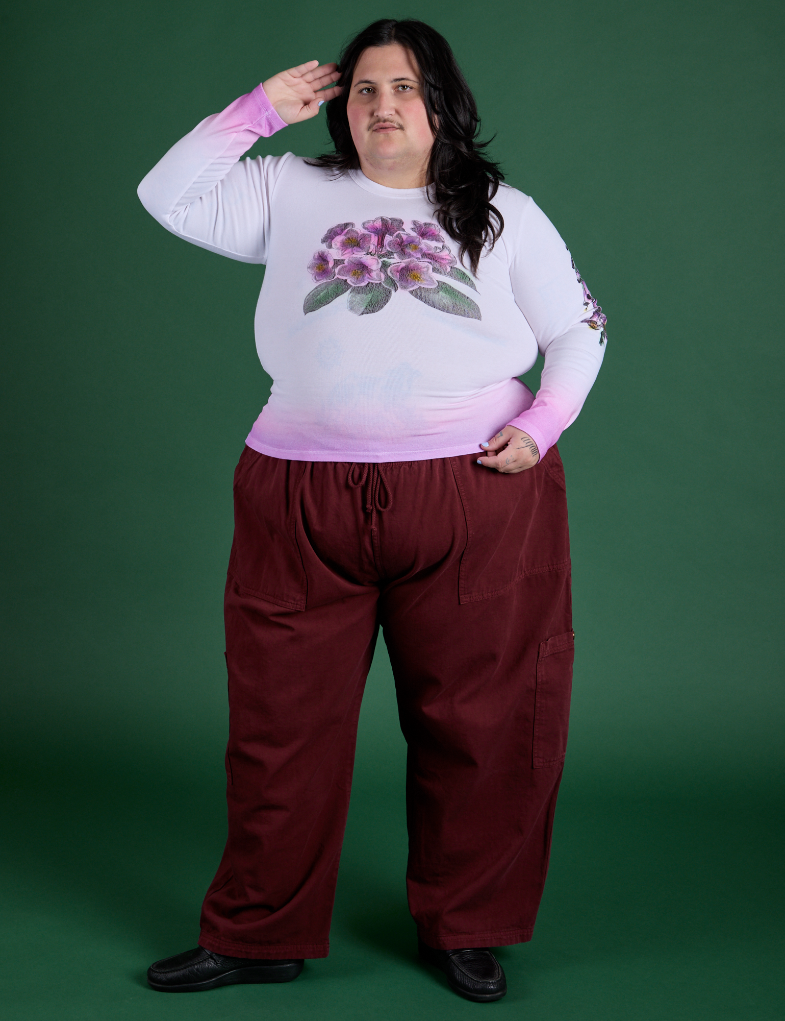 Sam is wearing Floral Long Sleeve Baby Tee in Pink paired with red wine Drop Pocket Cargo Pants
