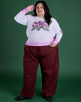 Sam is wearing Floral Long Sleeve Baby Tee in Pink paired with red wine Drop Pocket Cargo Pants