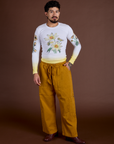 Jesse is wearing Floral Long Sleeve Baby Tee in Yellow and spicy mustard Drop Pocket Cargo Pants