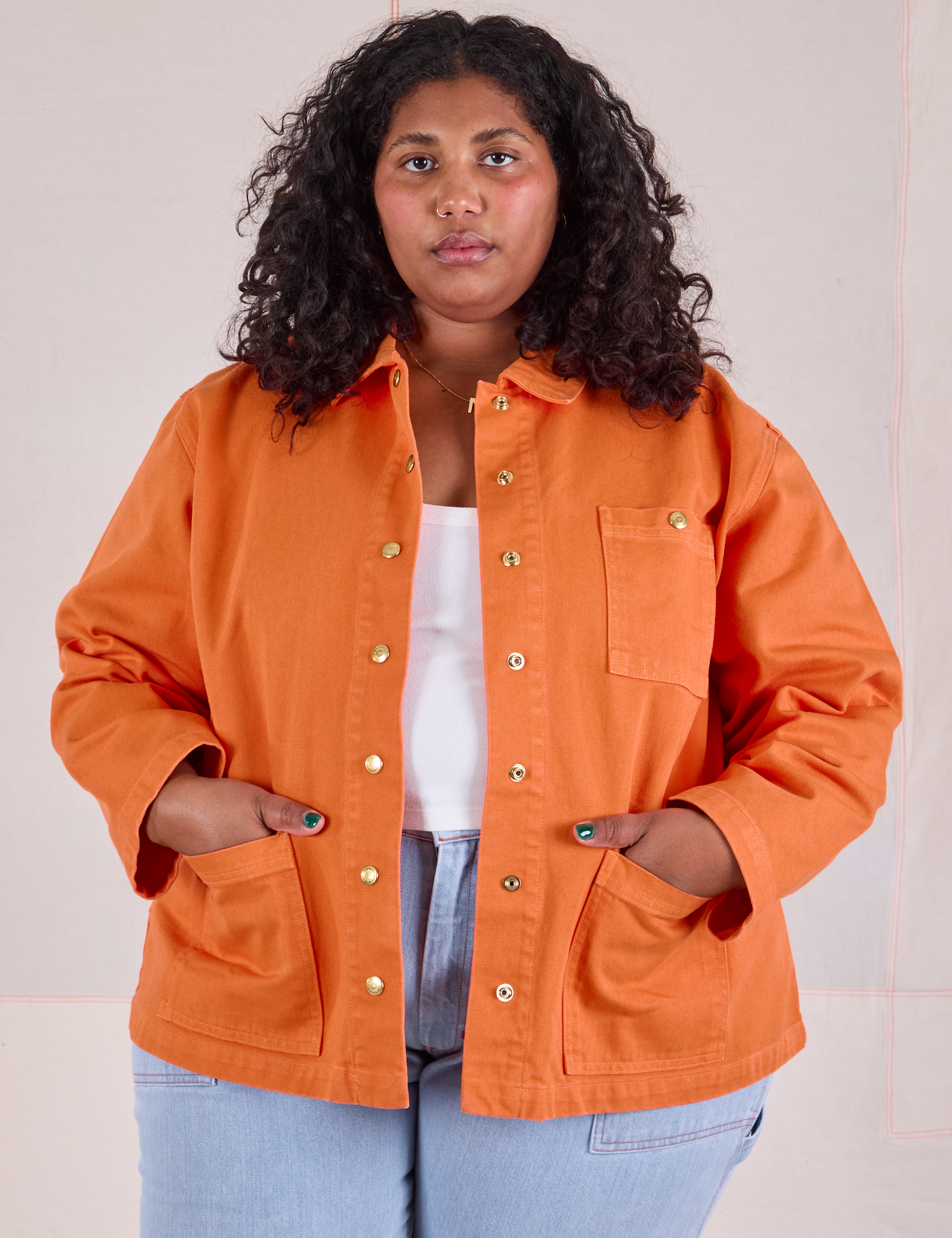 Morgan is 5&#39;5&quot; and wearing 1XL Denim Work Jacket in Construction Orange