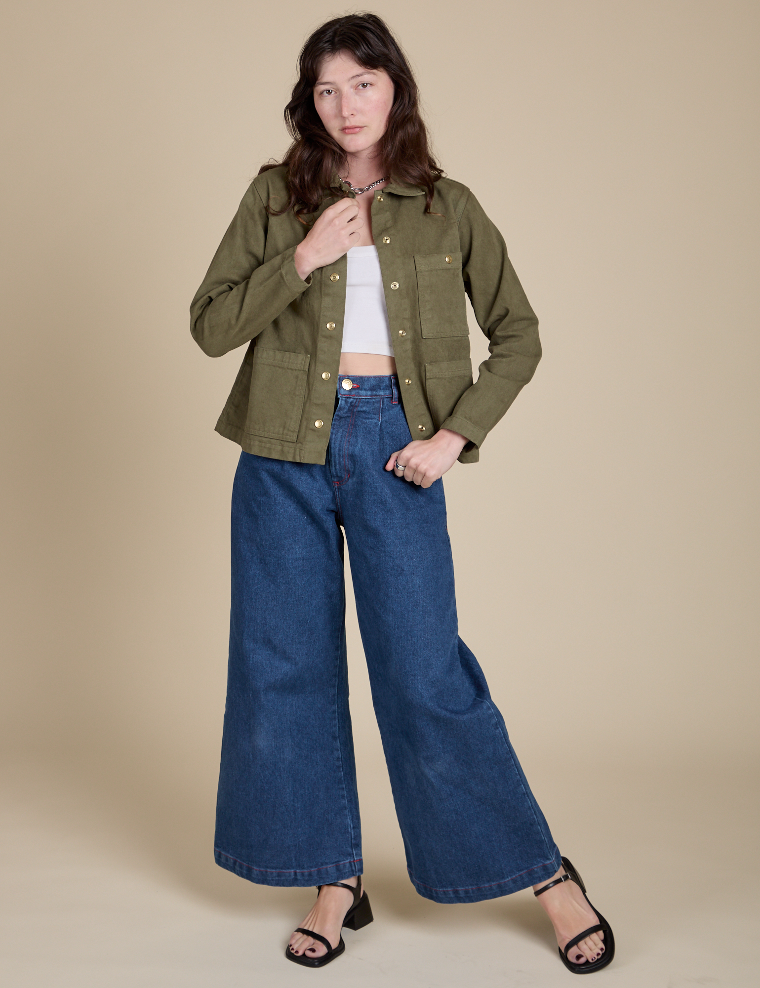 Alex is wearing Denim Work Jacket in Surplus Green and dark wash Indigo Wide Leg Trousers