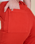 Close up of Alex's hand in the back pocket of Work Pants in Mustang Red