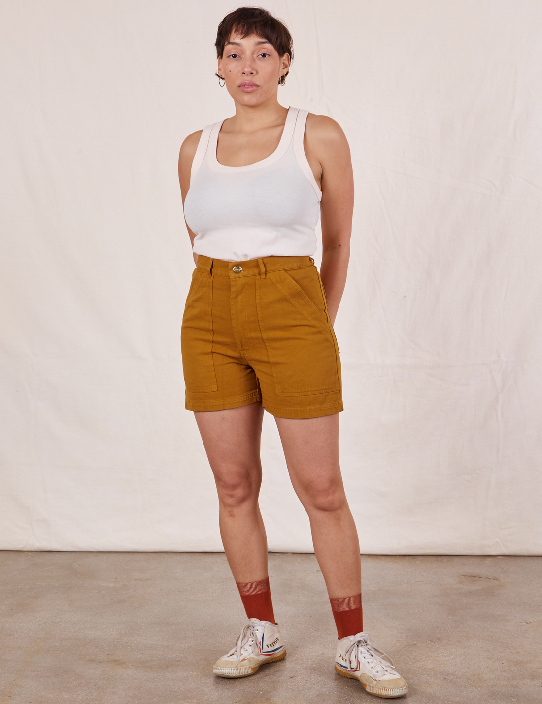 Tiara is wearing Classic Work Shorts in Spicy Mustard and vintage off-white Tank Top