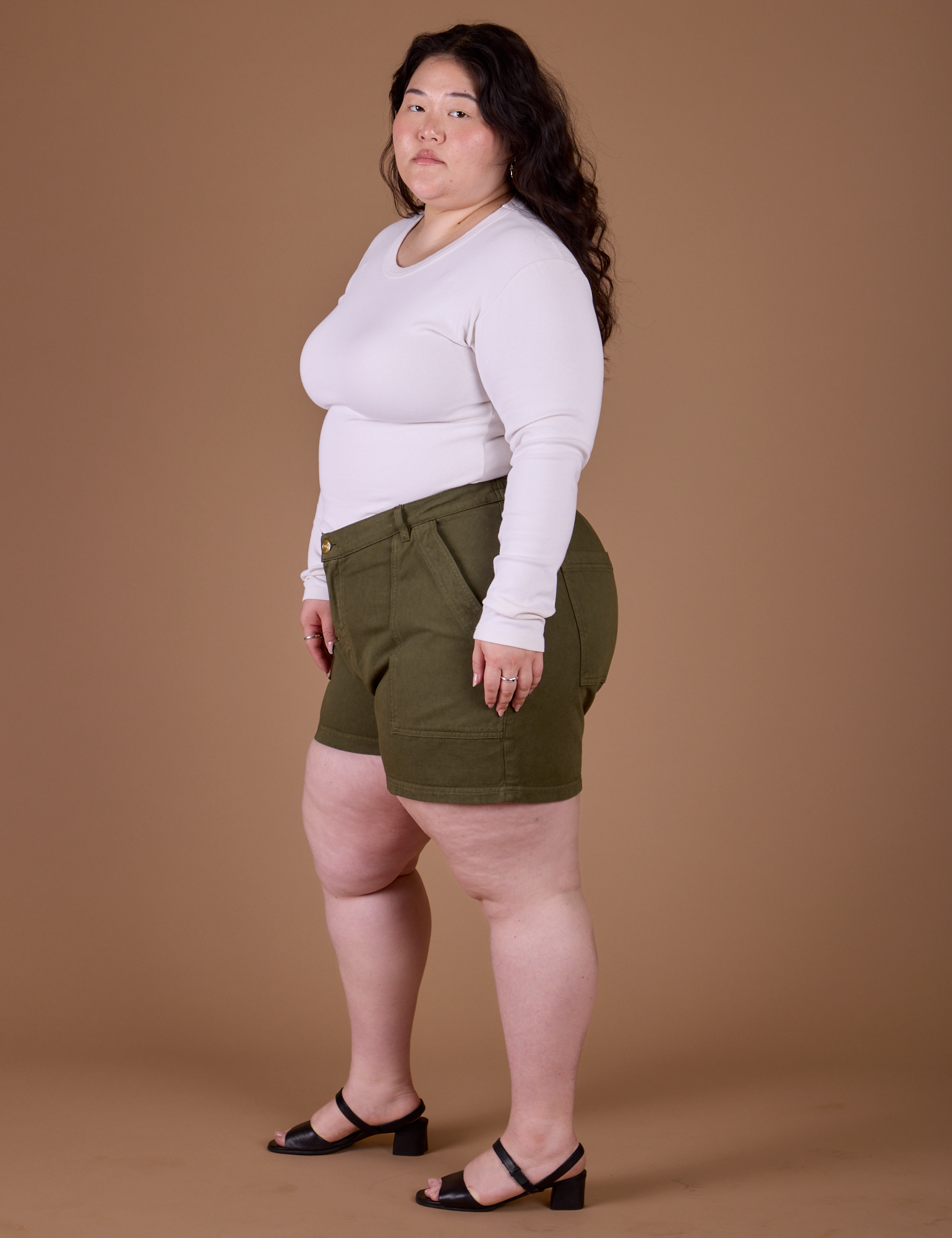 Side view of Classic Work Shorts in Surplus Green and vintage tee white Long Sleeve Baby Tee