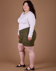 Side view of Classic Work Shorts in Surplus Green and vintage tee white Long Sleeve Baby Tee