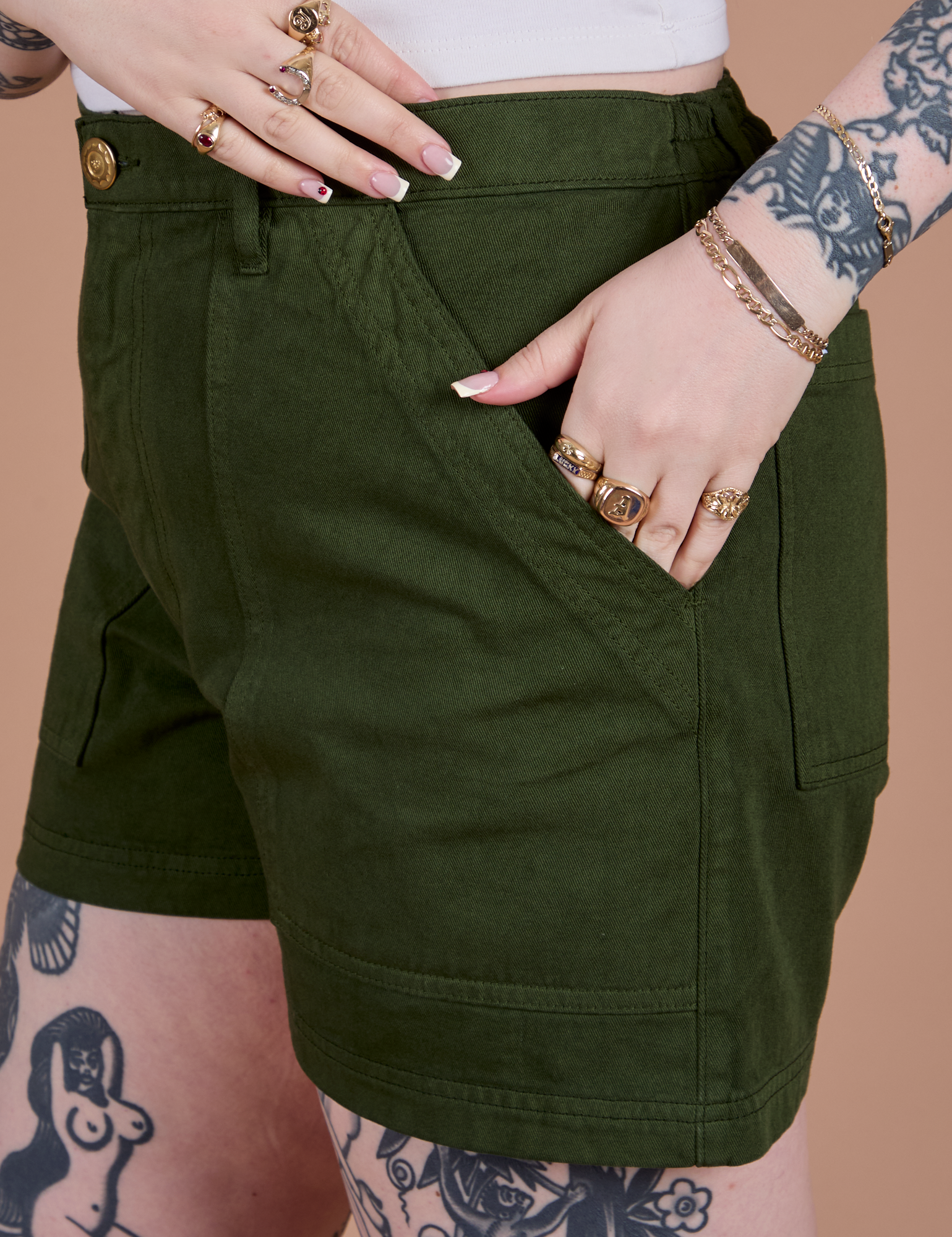 Close up of Sydney's hand in the front pocket of Classic Work Shorts in Evergreen