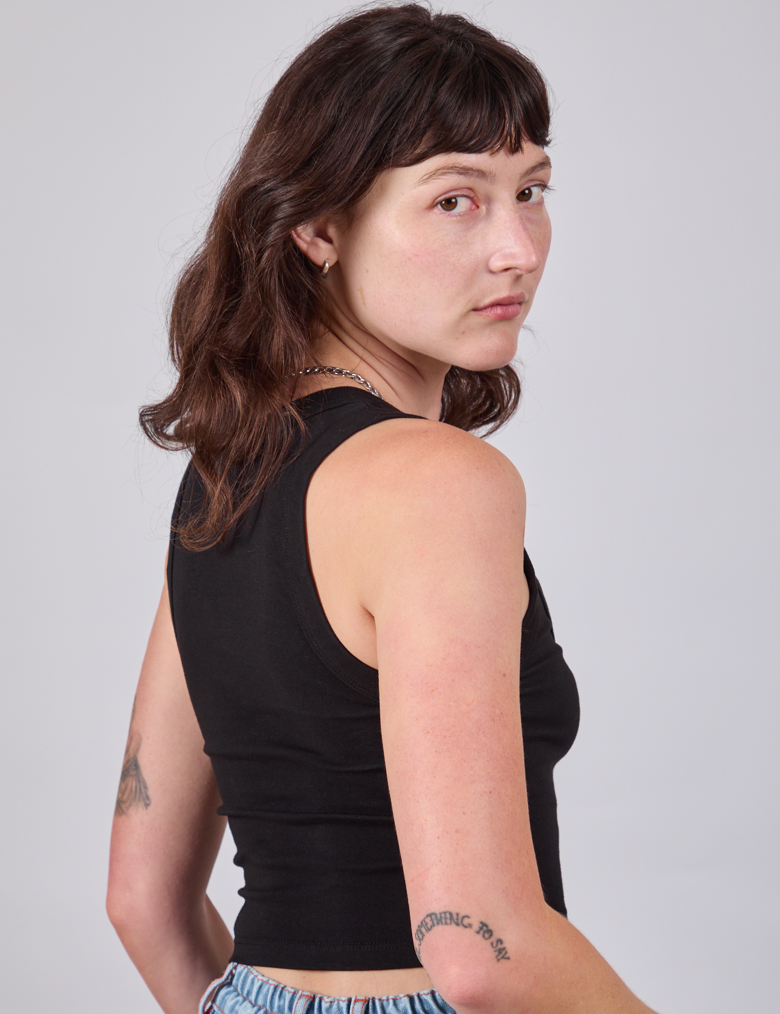 Cropped Tank Top in Basic Black angled back view on Alex