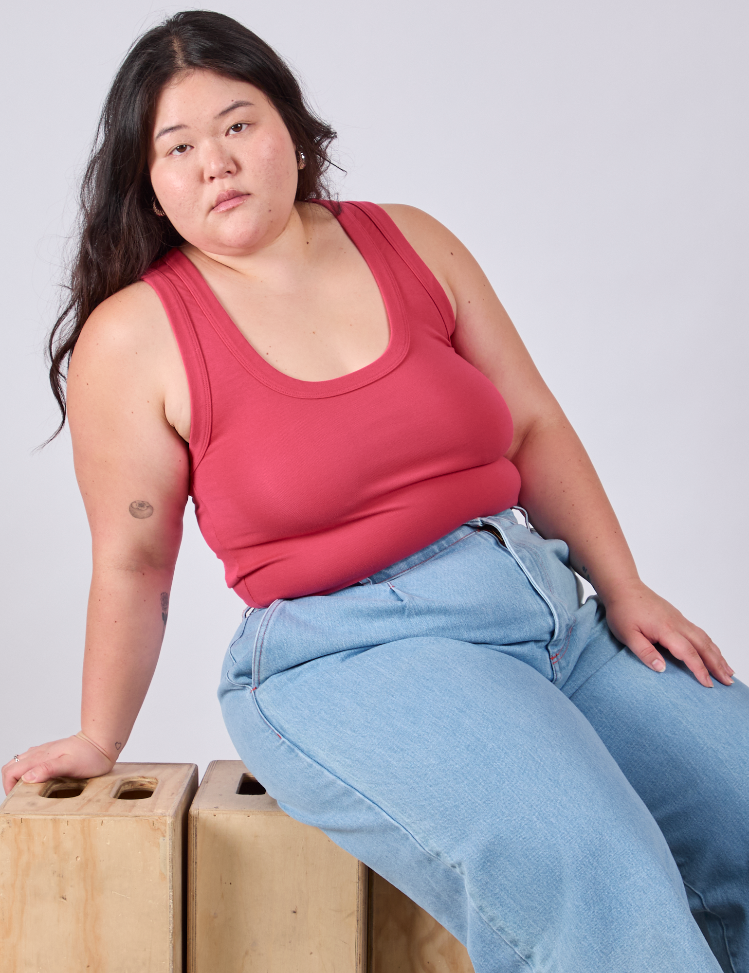 Ashley is wearing Cropped Tank Top in Hot Pink and light wash Wide Leg Trousers