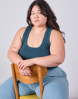 Ashley is wearing Cropped Tank Top in Lagoon and sitting in a chair