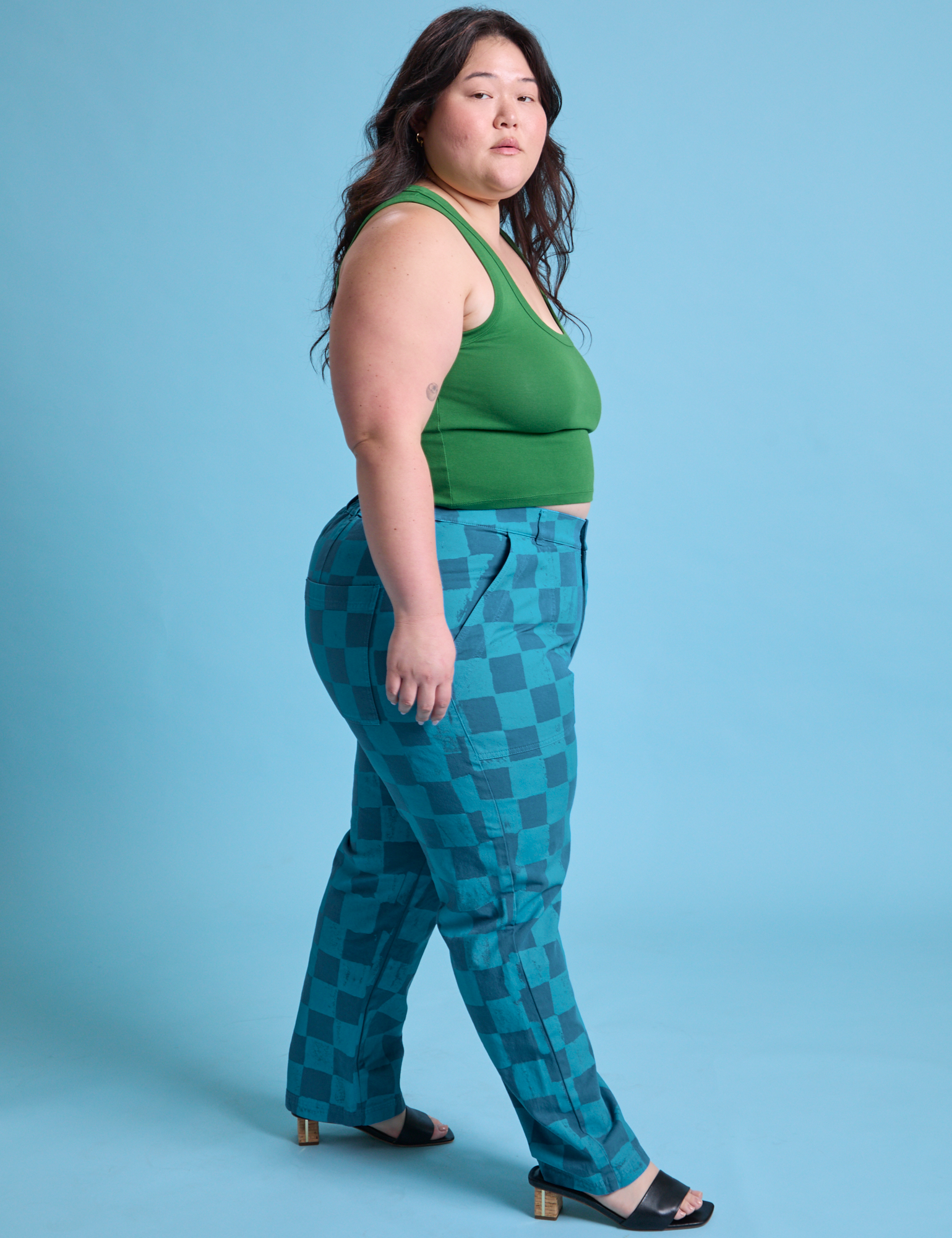 Side view of Checkerboard Work Pants in Blues and lawn green Cropped Tank on Ashley