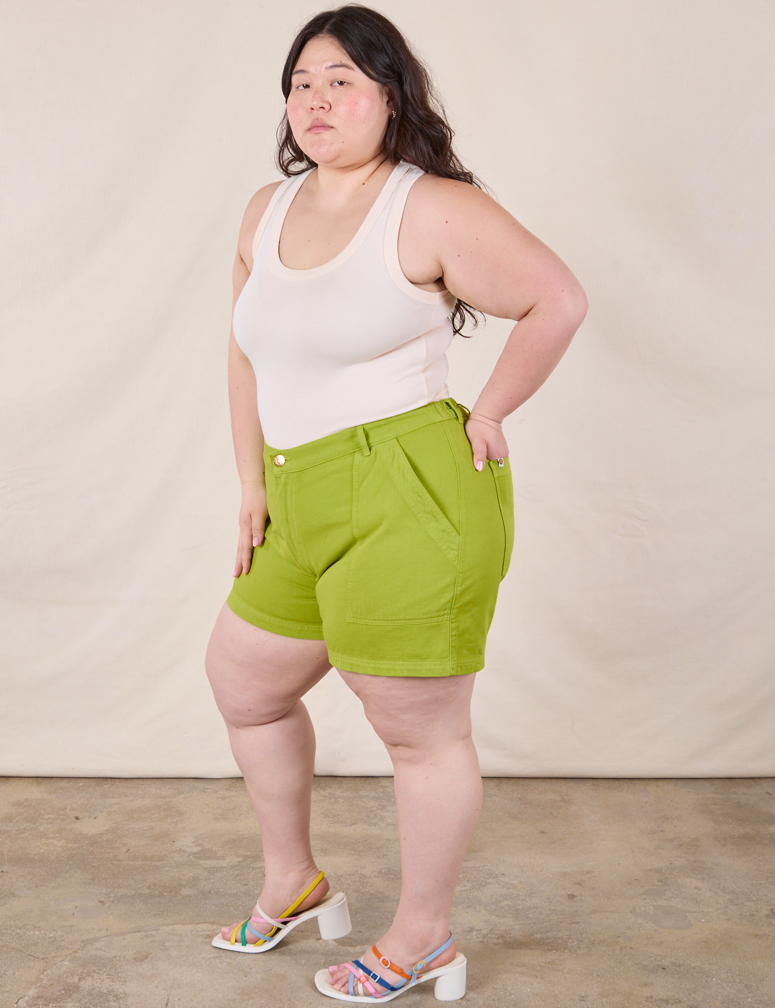 Side view of Classic Work Shorts in Gross Green and Tank Top in Vintage Tee Off-White on Ashley