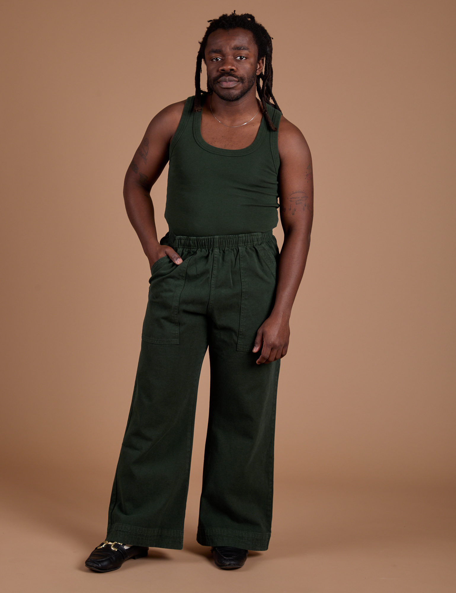 Demi is wearing Action Pants in Swamp Green and Tank Top in Swamp Green