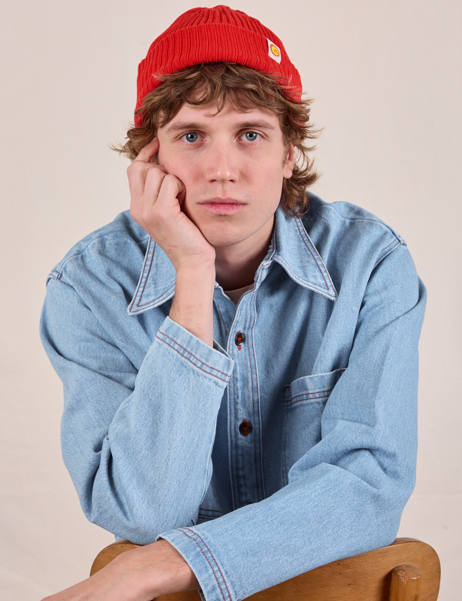 Quinn is wearing the Ribbed Beanie in Mustang Red