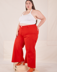 Angled view of Bell Bottoms in Mustang Red and vintage off-white Halter Top on Marielena