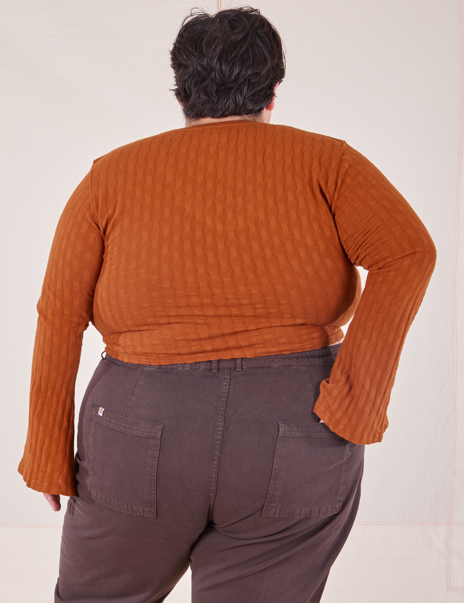 Back view of Bell Sleeve Top in Burnt Terracotta and espresso brown Western Pants worn by Sam