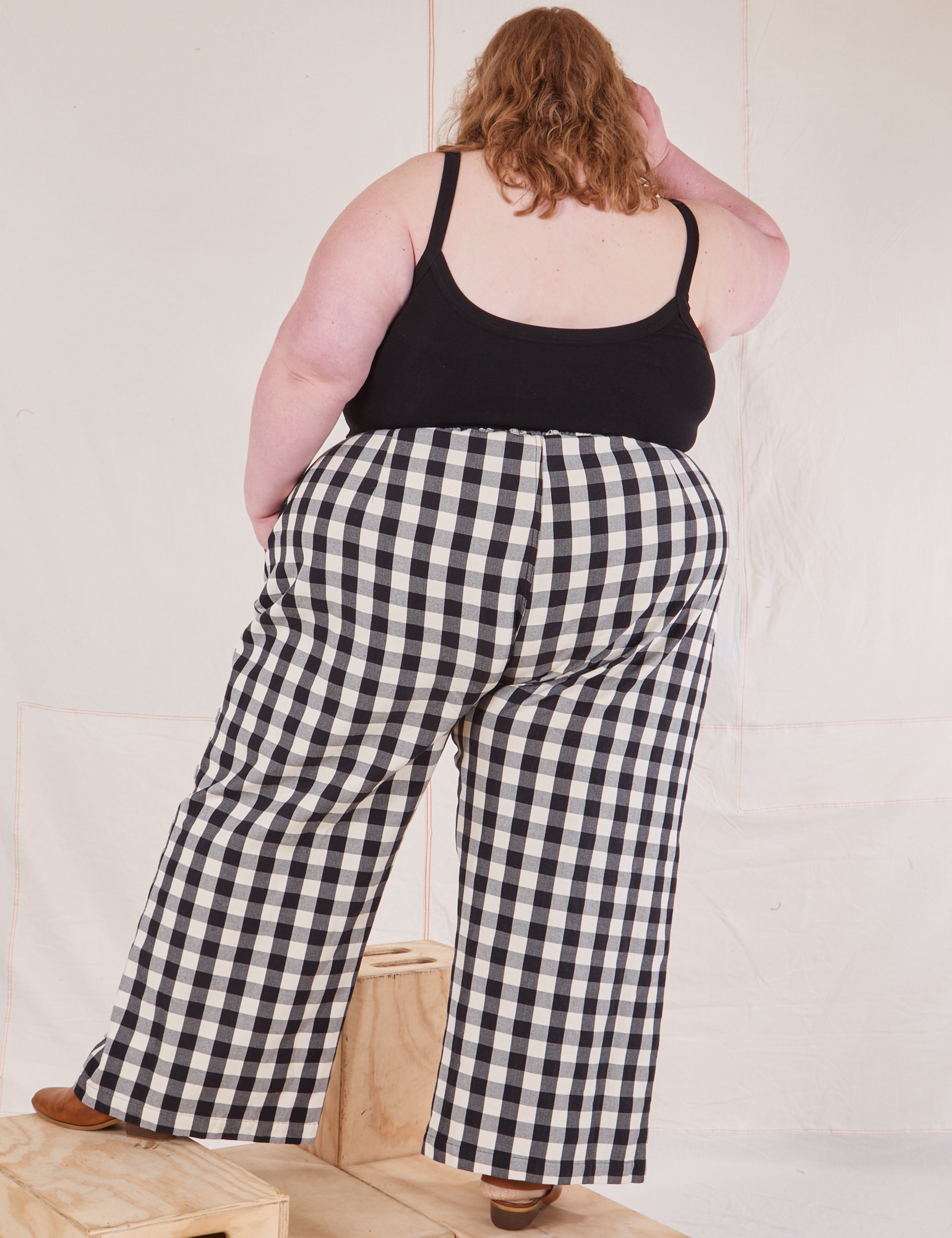 Back view of Wide Leg Trousers in Big Gingham and black Cropped Cami on Catie