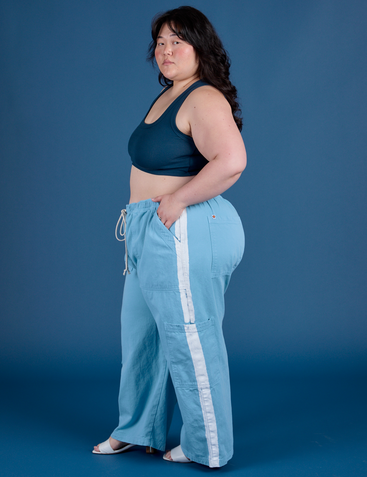 Side view of Painted Drop Pocket Cargo Pants in Baby Blue and lagoon Mini Tank on Ashley