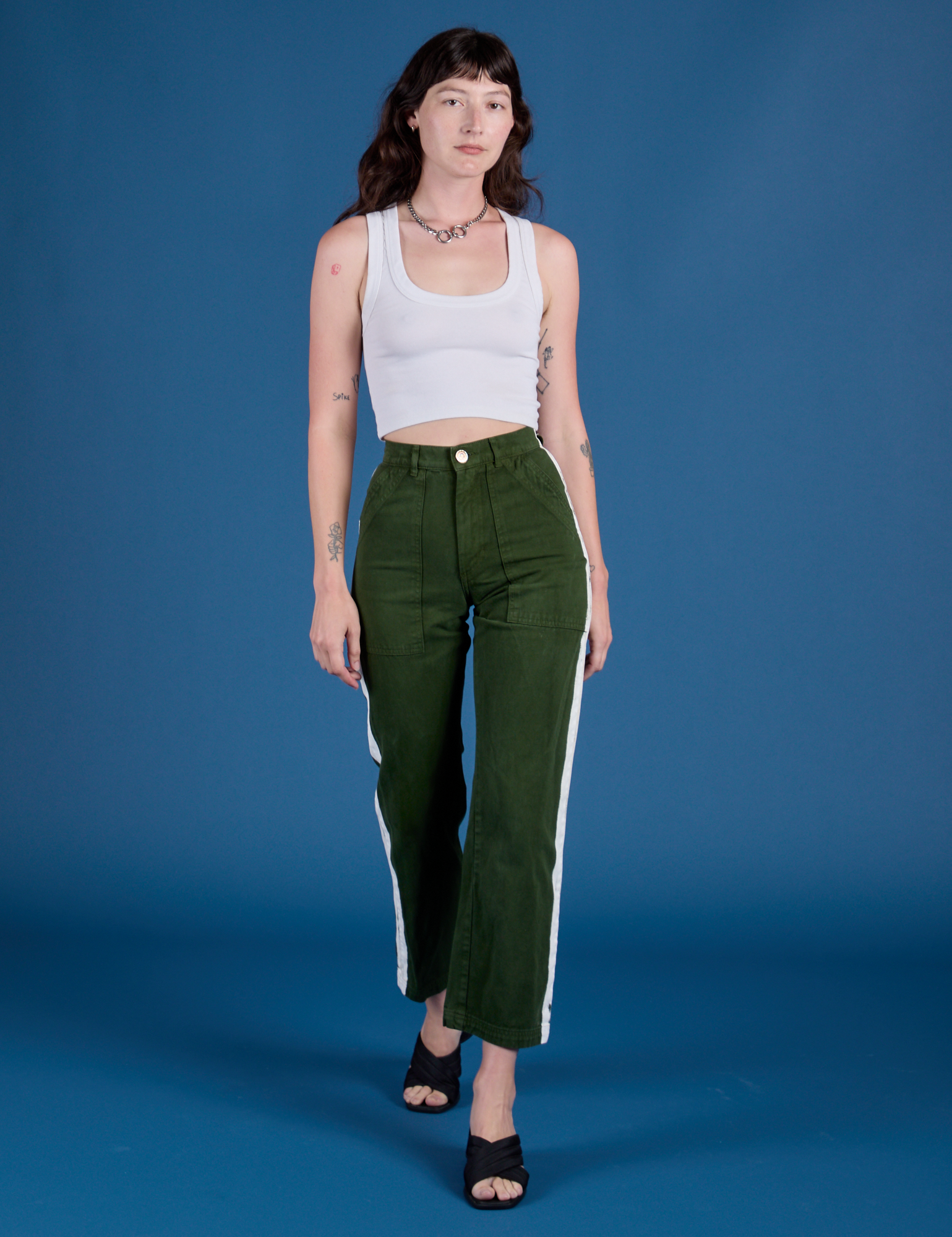 Alex is wearing Painted Work Pants in Evergreen and vintage tee white Cropped Tank