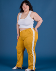 Angled front view of Painted Work Pants in Mustard Yellow and vintage tee white Cropped Tank on Ashley