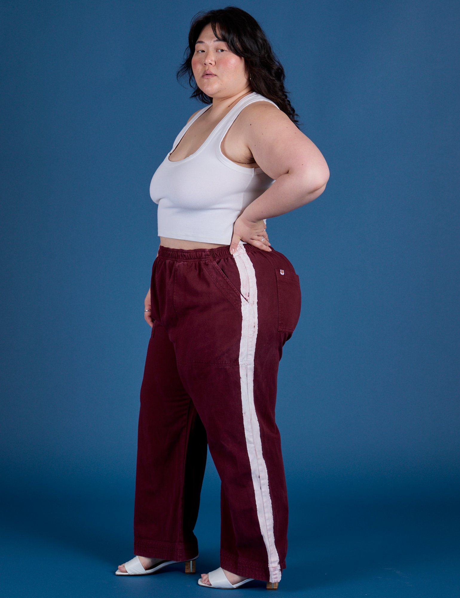 Side view of Painted Action Pants in Red Wine and vintage tee white Cropped Tank on Ashley