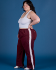 Side view of Painted Action Pants in Red Wine and vintage tee white Cropped Tank on Ashley