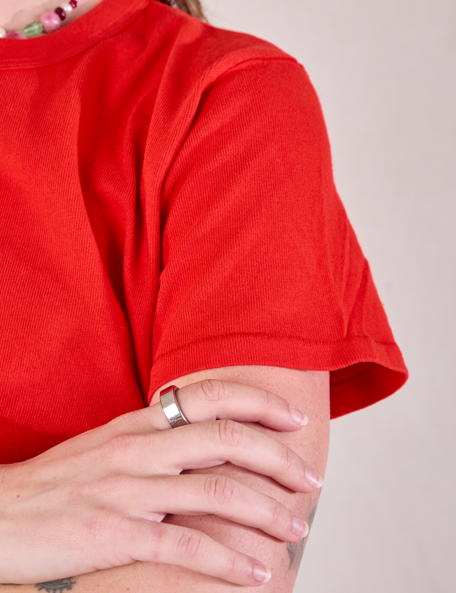 Burly Tee in Mustang Red sleeve close up on Alex