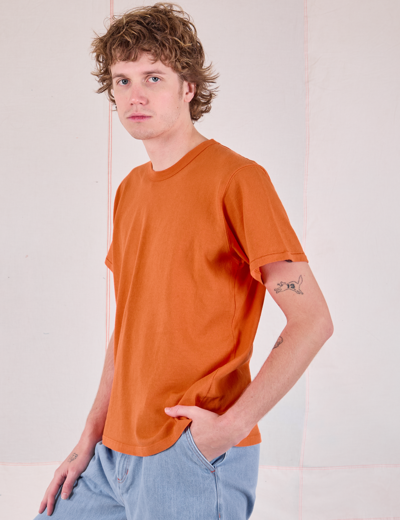 Burly Tee in Construction Orange front angled view on Quinn