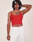 Jerrod is wearing Cropped Cami in Mustang Red and vintage off-white Western Pants