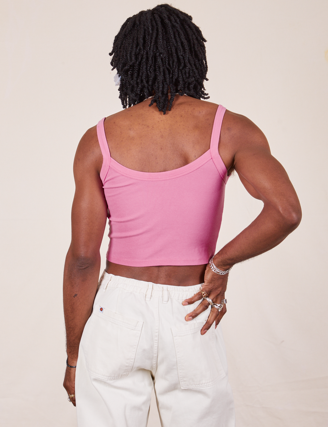Back view of Cropped Cami in Bubblegum Pink and vintage off-white Western Pants worn by Jerrod