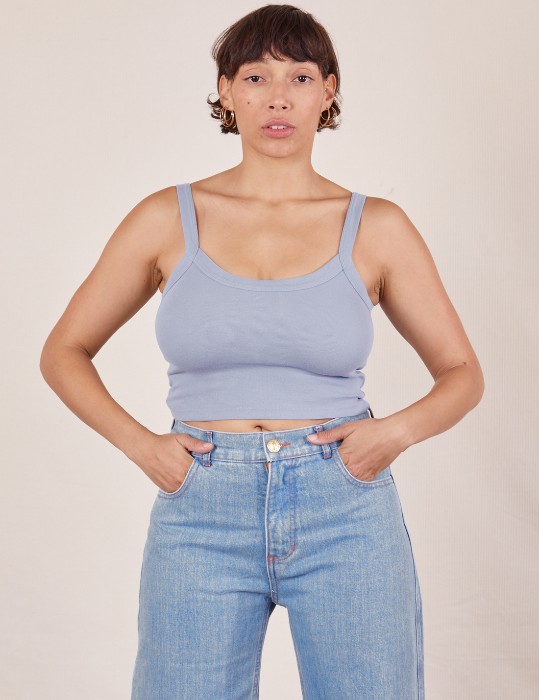 Tiara is 5'4" and wearing XS Cropped Cami in Periwinkle paired with light wash Sailor Jeans