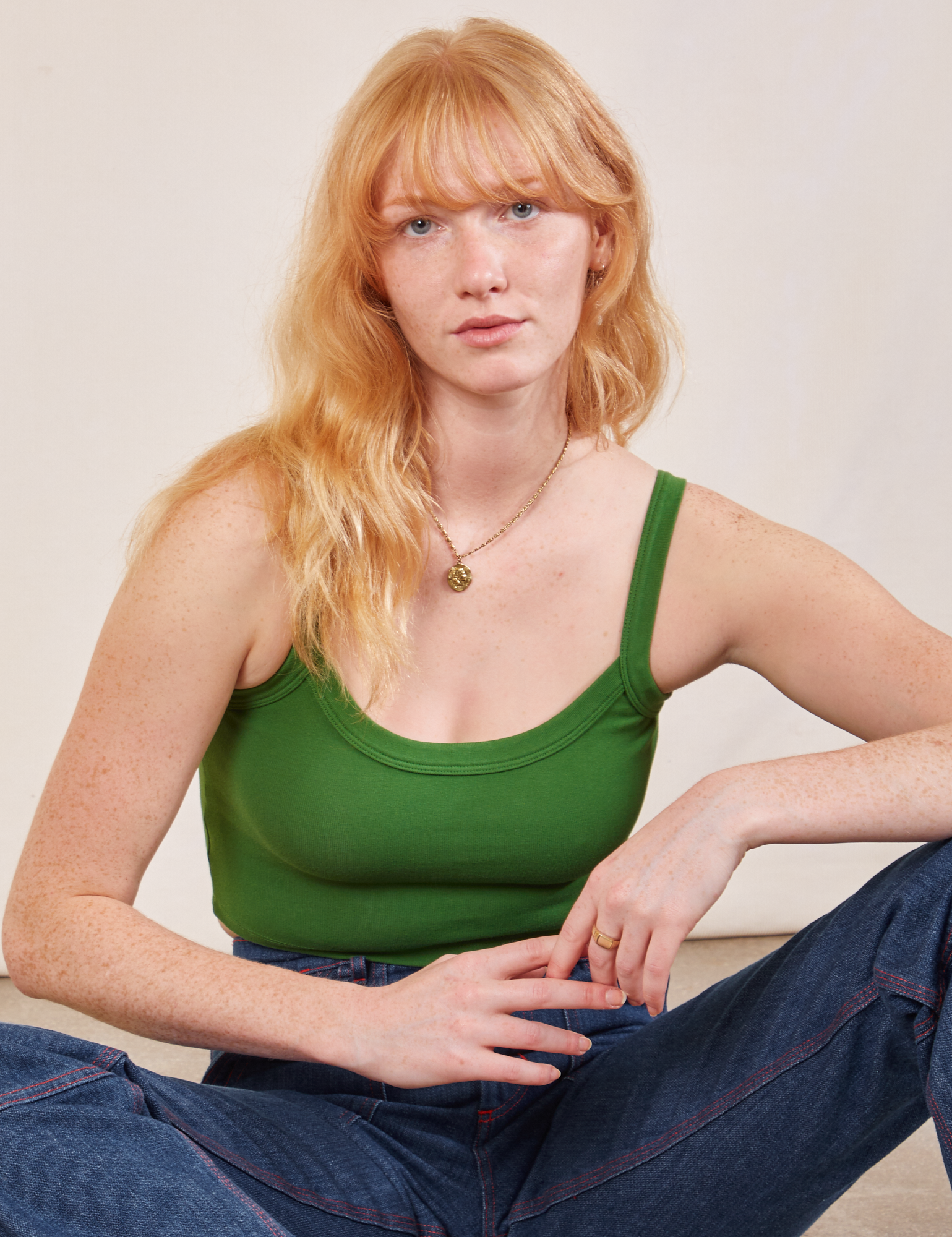 Margaret is wearing Cropped Cami in Lawn Green and dark wash Carpenter Jeans