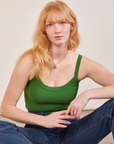 Margaret is wearing Cropped Cami in Lawn Green and dark wash Carpenter Jeans