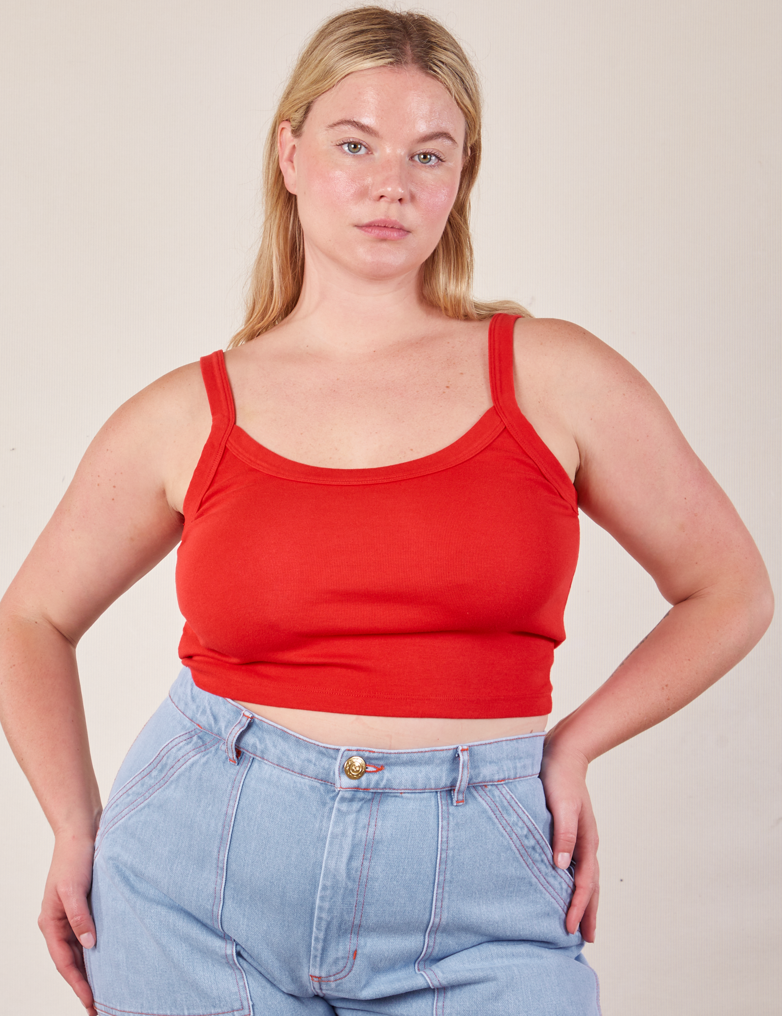 Lish is wearing Cropped Cami in Mustang Red and light wash Carpenter Jeans