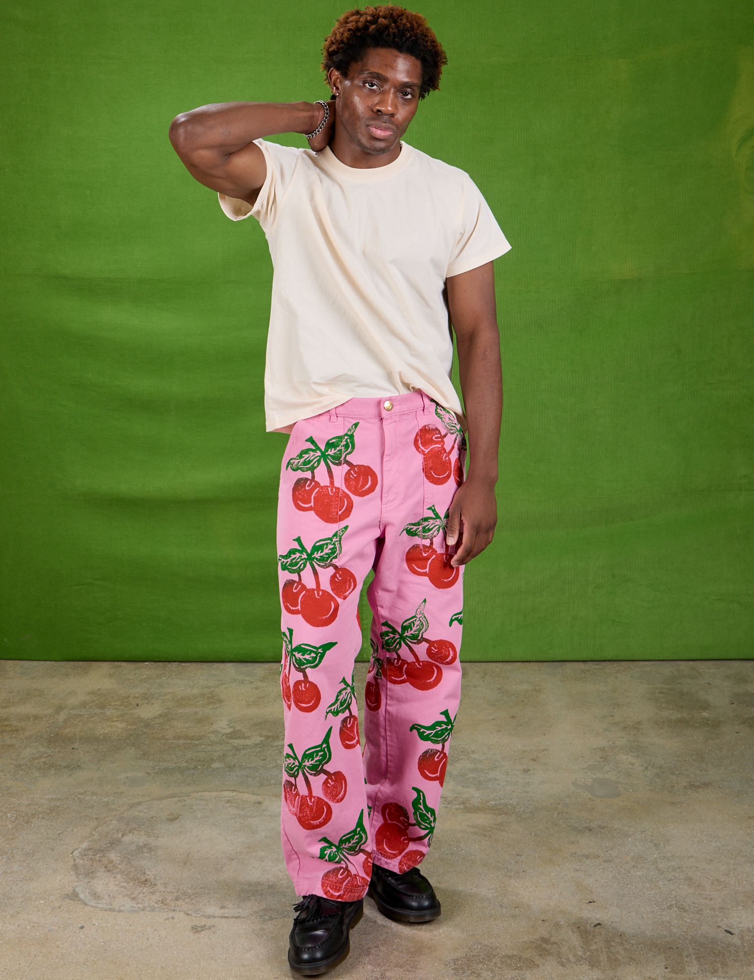 Isaac is 5&#39;10&quot; and wearing M Cherry Paintstamped Work Pants in Bubblegum Pink paired with The Organic Vintage Tee in Vintage Off-White