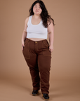 Ashley is 5’7” and wearing 1XL Carpenter Jeans in Fudgesicle Brown paired with a Cropped Tank in Vintage Tee White