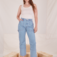 Allison is 5'10" and wearing S Carpenter Jeans in Light Wash paired with vintage off-white Tank Top