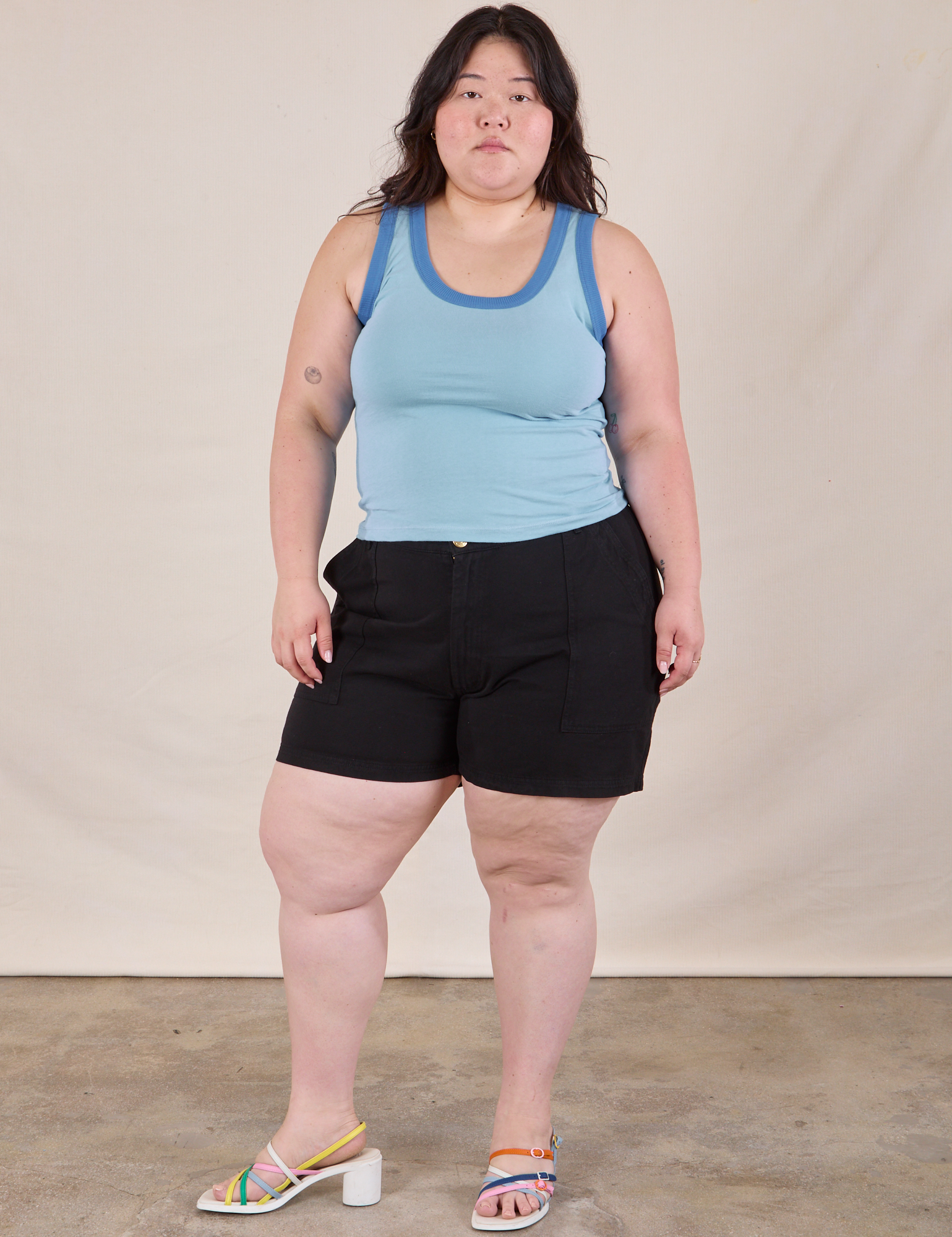 Ashley is wearing Colorblock Cropped Tank in Baby Blue and black Work Shorts