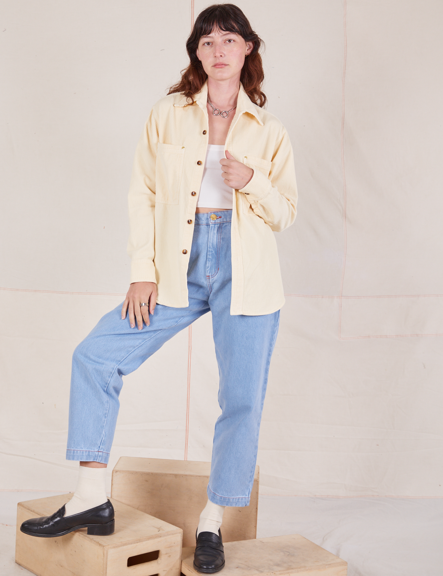 Alex is wearing Corduroy Overshirt in Vintage Off-White with a vintage off-white Cropped Cami underneath and light wash Denim Trouser Jeans